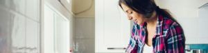 A woman cleaning in her kitchen