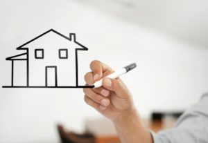 A person draws an image of a house