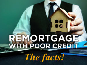 Man holds wooden home and sign remortgage.