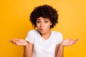 Close-up portrait of her she nice attractive puzzled ignorant wavy-haired girl showing gesture no information isolated on bright vivid shine yellow background